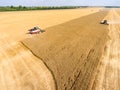 Reaping thresher machines are on agricultural field during crop year, harvesting cereal, Russia