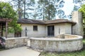 Rear angle view of brown spanish style stucco and cinder block 1970's house with a round semi-circle patio Royalty Free Stock Photo