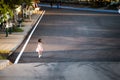 Rear back view of Asian kid girl jogging in park on summer or spring evening. Child play sports for good health. Children 5 years