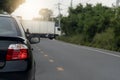 Rear of the black car turn on brake light for stop on asphalt road. Royalty Free Stock Photo