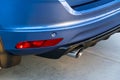 Rear bumper of a car with exhaust pipe, modern car exterior details.