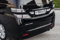 Rear bumper of Toyota Vellfire japanese luxury minivan car in black color on the parking with seven passenger seats Royalty Free Stock Photo