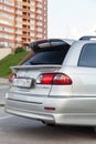 Rear bumper and trunk view of Toyota Caldina car of 2000 release in the back of a silver T210 station wagon with two spoilers on