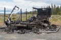 The rear of a burned out trailer by the side of the road Royalty Free Stock Photo