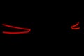 Rear car lights on a black background. Cars light trails. Night city road with traffic headlight. Light up road by vehicle. Car li Royalty Free Stock Photo