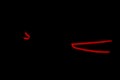 Rear car lights on a black background. Cars light trails. Night city road with traffic headlight. Light up road by vehicle. Car li Royalty Free Stock Photo