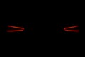 Rear car lights on a black background. Cars light trails. Night city road with traffic headlight. Light up road by vehicle. Car li Royalty Free Stock Photo