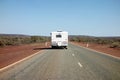 Rear of car towing a caravan in Western Australia in remote outback landscape