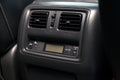 The rear central console on the panel inside the car close-up with climate control for heating or cooling passengers in gray and Royalty Free Stock Photo