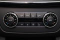 Rear central console on the panel inside the car close-up with climate control and seat heater buttons in gray and black. Auto Royalty Free Stock Photo