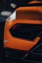 Rear close-up of a sleek, orange Lamborghini