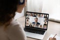 Rear view of female employee have online meeting on laptop