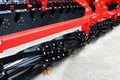 Rear detail of notched discs on modern disc harrows Akpil Bison XL, made in Poland. Spiral cultivating rear elements also visible.