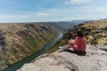 Rear of a female sitting and ejoying Fraga do Puio Lookout scenic spot view Royalty Free Stock Photo