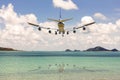 Rear image commercial passenger aircraft or cargo transportation airplane flying over coast of sea to cloud blue sky after takeoff Royalty Free Stock Photo