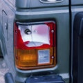 The rear lamp of the silver car broken by the accident.