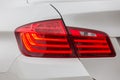 The rear left headlight of a modern car is white.