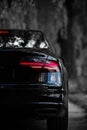 Rear light of a modern black car. Detail of car. Concept of expensive, sports auto. Royalty Free Stock Photo