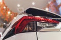 Rear light of a modern car close-up, white body. Royalty Free Stock Photo