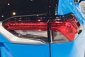 Rear light of a modern car close-up, white body. blue body Royalty Free Stock Photo