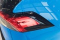 Rear light of a modern car close-up, white body. blue body Royalty Free Stock Photo