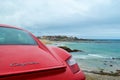 Rear light of a red Porsche Cayman 2.7 sport car, parked in fr