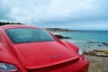 Rear light of a red Porsche Cayman 2.7 sport car, parked in fr