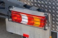 Rear lights of a new truck, close-up. Fragment of the back of the truck. Red brake lights and orange turn signals. Road Royalty Free Stock Photo