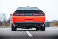 The rear of an orange Dodge Challenger American supercar