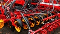 Rear part of modern Swedish pneumatic seed drill Vaderstad Spirit 400 C, with visible grain tubes, rakes, covering discs.