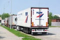 Rear part of Schmitz Cargobull semi-trailer and truck of TQM logistics company