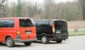 Rear part side view of two new passenger luxury vans A Volkswagen Transporter red and a Mercedes-Benz Viano car