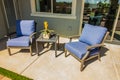 Rear Patio With Small Table & Two Arm Chairs With Blue Cushions Royalty Free Stock Photo