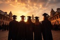 Rear perspective of university graduates, their silhouettes against graduation backdrop