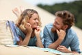 rear portrait young tourist couple laying together on beach Royalty Free Stock Photo