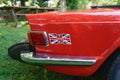 Rear quarter panel of a red Triumph TR6