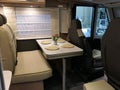 Rear seats and arranged dining table in modern german camper van Knaus Live I650 MEG Royalty Free Stock Photo