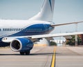 Rear section of white and blue colored passenger aircraft Royalty Free Stock Photo