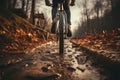 Rear shot Mountain bikes tire and riders foot on rustic dirt trail