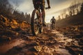 Rear shot Mountain bikes tire and riders foot on rustic dirt trail
