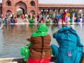 Rear shot of women washing at jama masjid mosque in old delhi