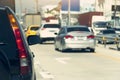 Rear side of black car stop on the concrete road in traffic junction. Royalty Free Stock Photo