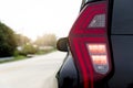 Rear side of black close up of tail light with open brake and turn light. Royalty Free Stock Photo