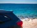 Rear side of the car and beautiful clear blue sea Royalty Free Stock Photo