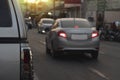 Rear side of car driving on the asphalt road with blurred of other cars in the city. Royalty Free Stock Photo