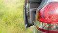 Rear side of gray car close-up on car tail light red color. Royalty Free Stock Photo