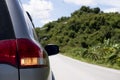 Rear side of gray car with open turn light signal on asphalt. Royalty Free Stock Photo