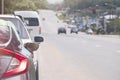 Rear side of gray car with turn on brake light. Parked in a queue on the side of the asphalt road. Royalty Free Stock Photo