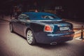 Rear side view of a very expensive premium Rolls-Royce Dawn car, luxury dark blue convertible
