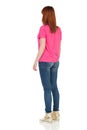 Rear Side View Of Young Standing Woman In Pink Shirt